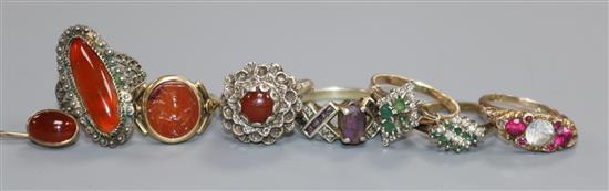 A signet ring with carnelian matrix, a carnelian stick pin, a 9ct gold scroll-carved ring and four other gold/silver gem-set rings